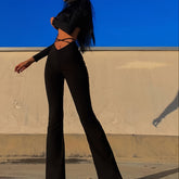 Solid Black High Waist Flare Leggings with Open Navel Criss Cross Straps - Body-Conforming & Fashion-Forward Wide Pants for Women